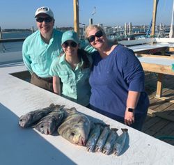 Two anglers with their catch of two fish at Orange Beach