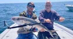 Image of two people fishing at the beach in Orange Beach