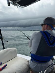 Fishing rod bent with catch on boat in Orange Beach AL waters