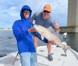 Two anglers with a large 22-inch fish at Orange Beach