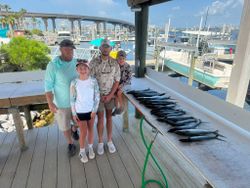 Successful fishing trip at Orange Beach AL marina with fresh caught fish displayed on cleaning table