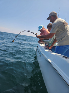3 people on a boat in Gulf Breeze enjoying cruises and fishing
