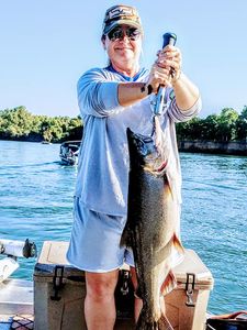 A person fishing with one caught fish in CA