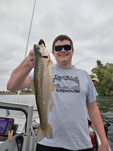 Angler with a beautiful rainbow trout in Corning