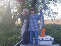 Two people fishing with rods in Corning