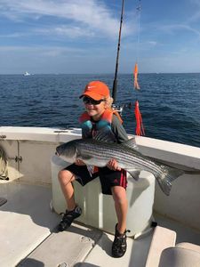 Kid enjoying some Cape Cod Striper Fishing