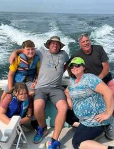 Group of 5 people fishing on the beach in Cape Cod