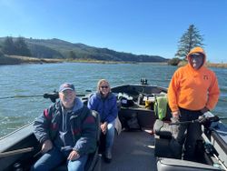 Three people enjoying a fishing trip in OR