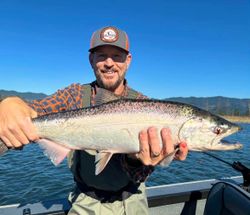 Angler with a large rainbow trout, fishing in Corvallis