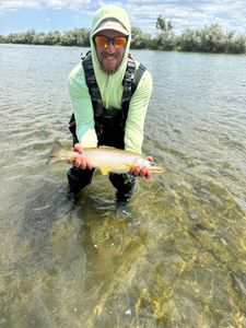 A fisherman at Cranberry Portage with a single fish