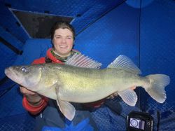 A fisherman holding a large walleye caught in Cranberry Portage