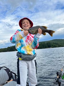 A lone angler fishing in the scenic Saranac Lake