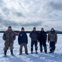Five people enjoying a fishing trip at Saranac Lake