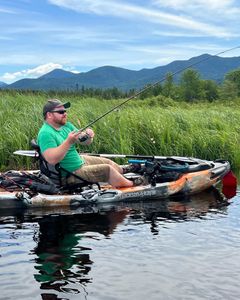 Person fishing on the shore of Saranac Lake