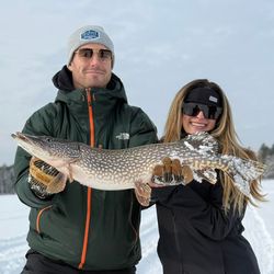 Angler holding a large northern pike fish caught in NY