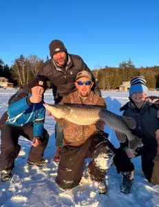 Angler with a large Northern Pike fish caught in Saranac Lake