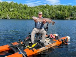 Angler with a 28-inch northern pike in Saranac Lake