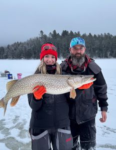 Angler with a northern pike fishing in Saranac Lake