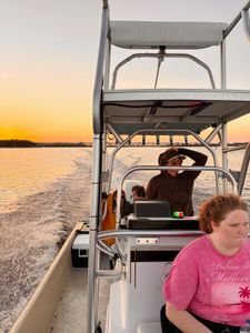 Fishing boat on water at sunset in Bagdad FL with tower and equipment
