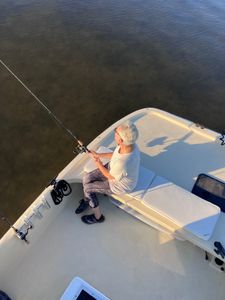 Fishing from white boat on calm waters near Bagdad FL