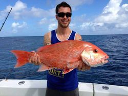 A person fishing in Galveston with a 30-inch fish