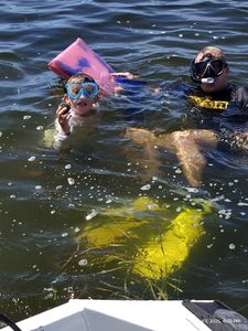 Two snorkelers in water with collection bag in Brooksville FL