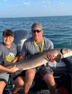 Two people fishing in MI