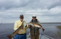 Two anglers fishing in FL with 2 big fish