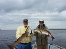 Two people fishing with 2 good-sized fish in Crawfordville