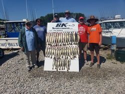 Six anglers enjoying a day of fishing at the lakeside in Marblehead