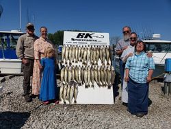 Five people enjoying a day of fishing at the lakeside in Marblehead