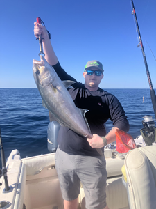 Reeling in a big one out on the open water.