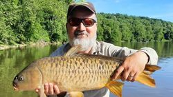 A lone fishing enthusiast reeling in a catch from the waters of West Virginia
