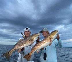 Two people fishing in Florida with two big fish