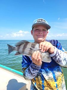 Angler holding a large Black Drum fish in Citrus County