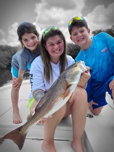 An angler reeling in a 21-inch catch at Citrus County