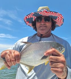 A lone Florida Pompano fish, measuring 13 inches, caught on a fishing trip in FL