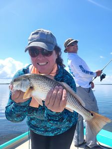 Angler holding a large redfish caught in Citrus County