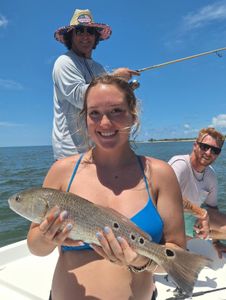 Fisherman catching a large redfish in Florida