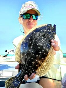 Angler with a summer flounder catch in FL