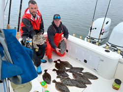 Two anglers smiling while fishing in New Jersey