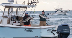 Two anglers holding large fish in New Jersey