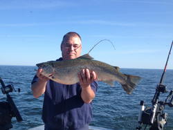 Angler holding a big rainbow trout in NY