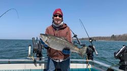 Angler holding a large rainbow trout fish caught in NY