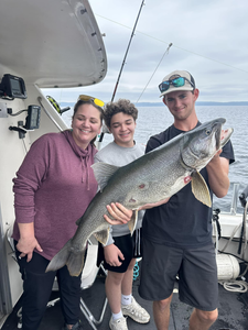 Three anglers with a large 29-inch fish caught in Superior