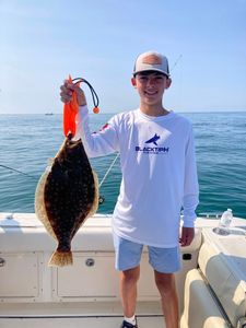 A fisherman holding a Southern Flounder in NJ