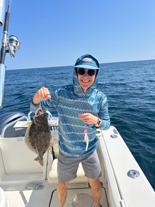 Nice summer flounder using deep sea jigging techniques in partly cloudy conditions.