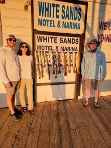 Trio of anglers with their fishing gear on the coast of TX