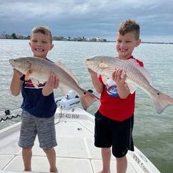 Two anglers fishing in FL with 19-inch fish