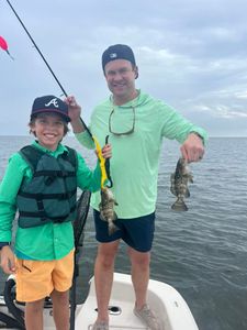 Two anglers fishing in Florida with 8-inch fish